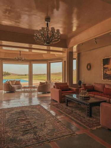 a large living room with couches and a table at Domaine Golfique Lamrah - 10 Suites in Marrakech