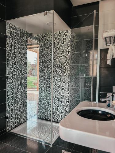 a bathroom with a shower with a sink and a tub at Domaine Golfique Lamrah - 10 Suites in Marrakech