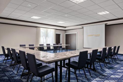 a conference room with a long table and chairs at Courtyard by Marriott Evansville East in Evansville
