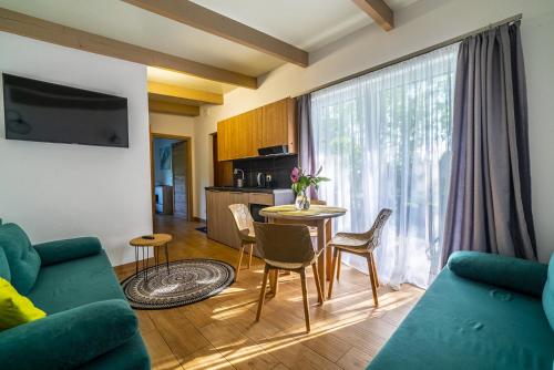 a living room with a couch and a table at Nowa Dana Ośrodek Wypoczynkowy in Łebcz