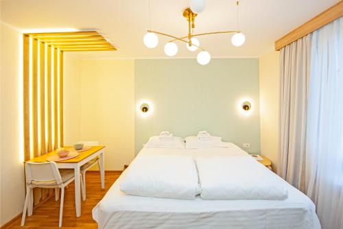 a bedroom with a large bed and a table at Cozy Lodge Kopaonik in Kopaonik