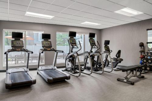 a gym with several treadmills and elliptical machines at Courtyard by Marriott Evansville East in Evansville