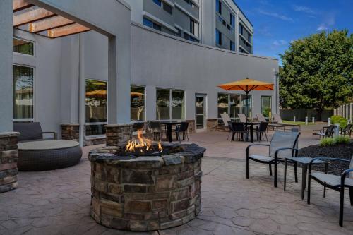 a patio with a fire pit and tables and chairs at Courtyard by Marriott Evansville East in Evansville