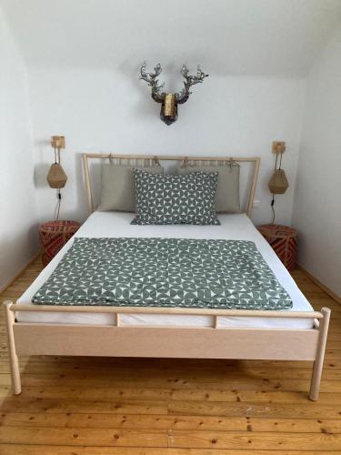 a large bed in a room with two lamps at Dottore Casa in Kirchberg am Wechsel