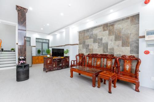 a living room with two benches and a wall at AMY homestay in Vung Tau