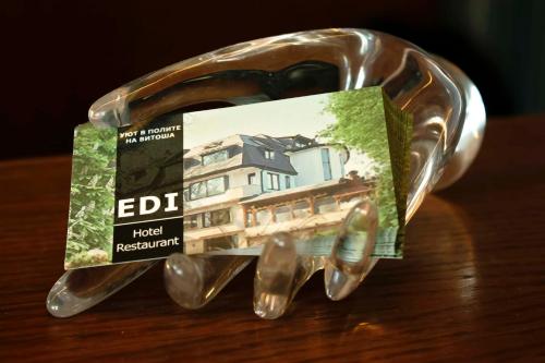 a bottle with a picture of a house in it at Edi Hotel in Sofia