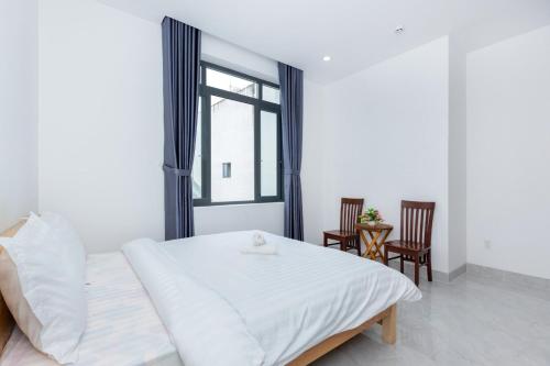 a bedroom with a bed and a window and chairs at AMY homestay in Vung Tau