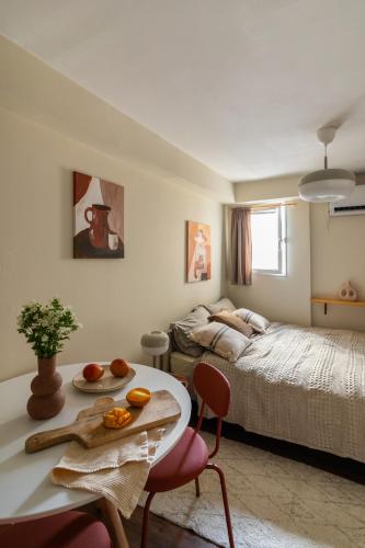 a bedroom with a bed and a table with oranges on it at Dotan's Boutique Studios - By Gordon Beach! in Tel Aviv
