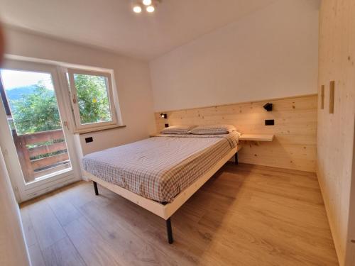 a bedroom with a bed and a window at Val Fassa in Campitello di Fassa