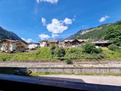 a view of a village with houses and mountains at Val Fassa in Campitello di Fassa