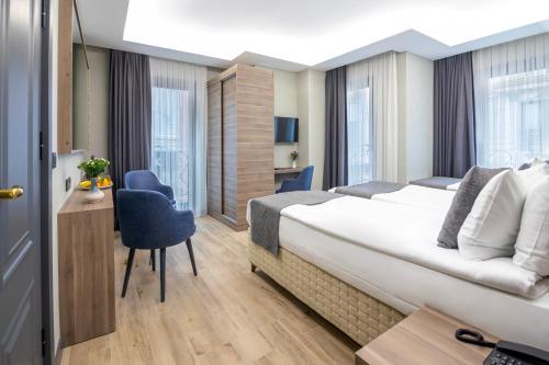 a hotel room with a bed and a desk at The Omiya Hotel in Istanbul