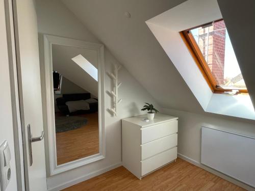 a room with a white dresser and a mirror at Q2 Apartment Hannover Döhren mit Ausblick in Hannover