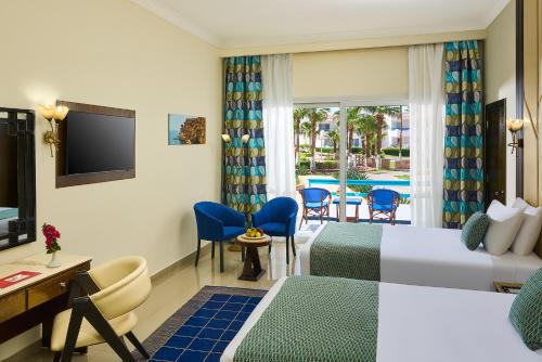 a hotel room with a bed and a television at Dreams Beach Resort - Sharm El Sheikh in Sharm El Sheikh