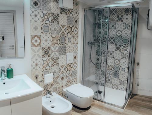 a bathroom with a shower and a toilet and a sink at Pietra Bianca in Santeramo in Colle