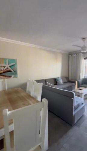 a living room with a couch and a table at Tranquility - Banana Beach Club in Port Shepstone