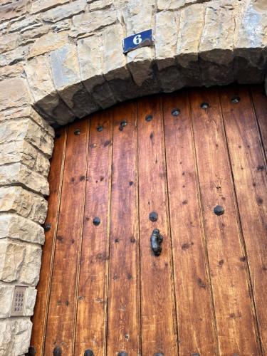 a wooden door in a stone wall at Casa Boixareu in La Pobla de Segur