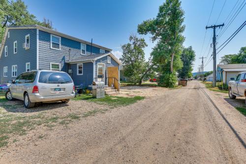 a house with a van parked on the side of a dirt road at Cozy Sturgis Retreat - Walk to Main St and Saloons! in Sturgis