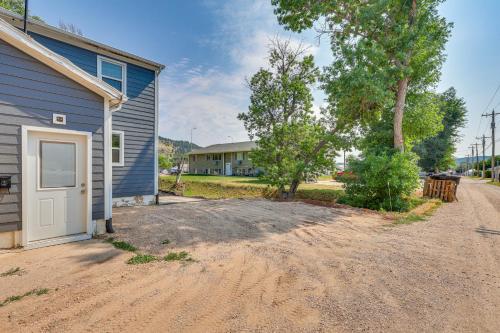 a dirt road next to a house with a garage at Cozy Sturgis Retreat - Walk to Main St and Saloons! in Sturgis