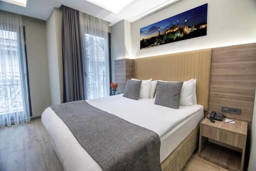 a hotel room with a large bed and a large window at The Omiya Hotel in Istanbul