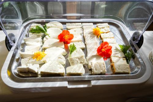 a tray of tofu with flowers on top of it at Panoramahotel Wagner - Das Biohotel am Semmering in Semmering