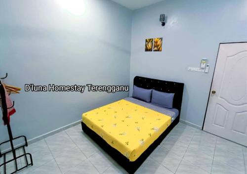 a bedroom with a yellow bed in a room at DLuna Homestay Terengganu in Kuala Terengganu