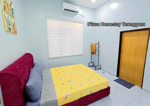 a bedroom with a bed and a window and a door at DLuna Homestay Terengganu in Kuala Terengganu