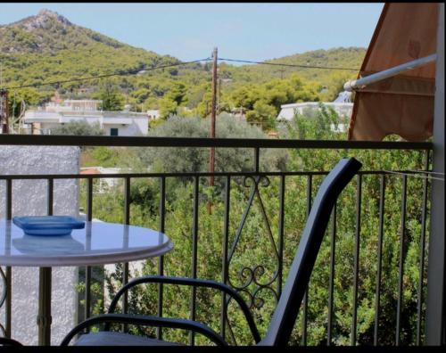 a table and chairs on a balcony with a view at Hermes in Agia Marina Aegina