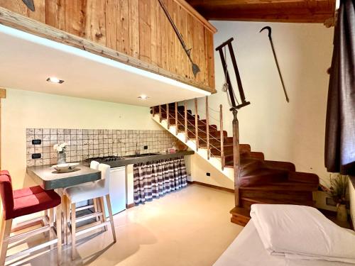 a kitchen with a sink and a staircase in a room at Maison Rosset agriturismo, camere, APPARTAMENTI e spa in Valle d'Aosta in Nus