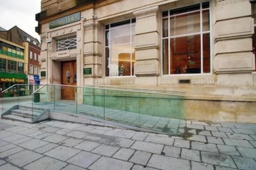 a facade of a building with a glass entrance at Palette Modern Newport City Center in Newport