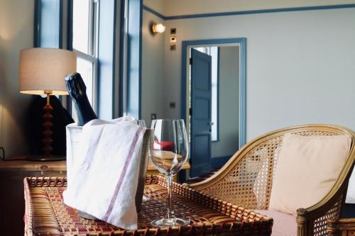 a table with a bottle of wine and a glass at The London & Paris Hotel in Folkestone