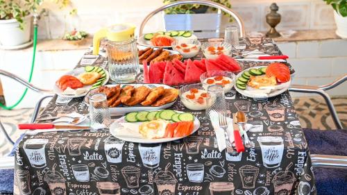a table with plates of food on top at Guest House Flowers in Berat
