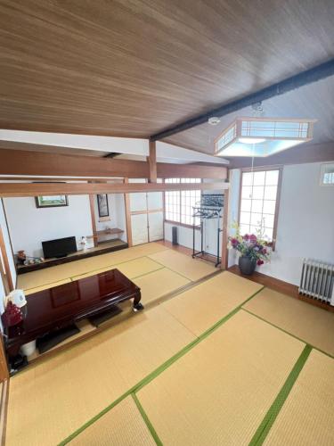 a large living room with a couch and a tv at 板東ビル in Tokyo