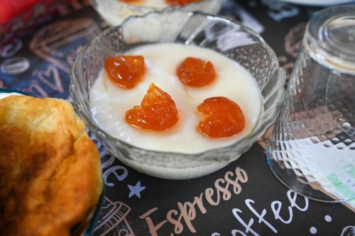 a bowl of yogurt with oranges on top of it at Guest House Flowers in Berat