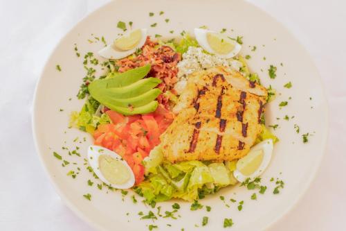 a white plate of food with meat and vegetables at Courtyard Palo Alto Los Altos in Palo Alto