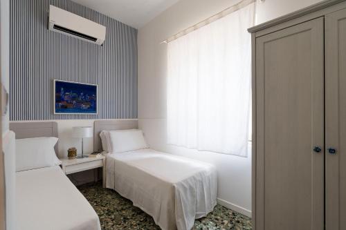 Ένα ή περισσότερα κρεβάτια σε δωμάτιο στο Brezza Marina