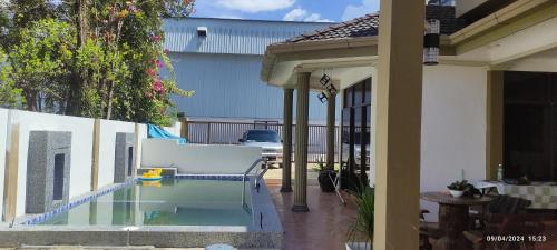 a swimming pool in the middle of a house at HOMESTAY ALORSETAR TOWNCENTRE by ASTARILA GUESTHOUSE-AmanCentral -iSLAM SAHAJA - 2storey Banglo, Private Pool, BBQ area & sports - max 30pax in Alor Setar