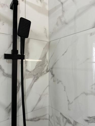 a microphone on a stand next to a marble wall at Avi Rooms in Chiaramonte Gulfi