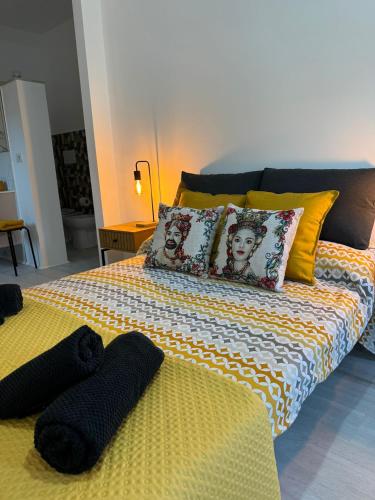 a bed with two black objects on top of it at Avi Rooms in Chiaramonte Gulfi