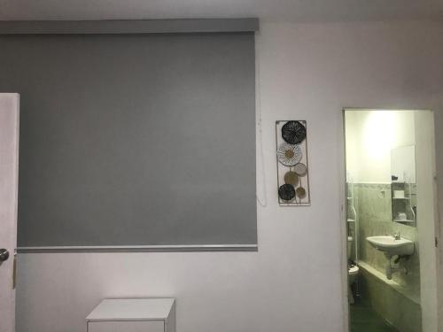 a bathroom with a toilet and a sink and a mirror at Albano apartamento 2 en casa vacacional in Mariscal Castilla