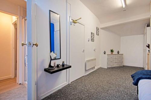 a bedroom with a bed and a mirror and a dresser at 5 minute walk from Bury city centre -1 bed flat in Bury