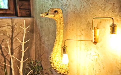a wall light with a fake ostrich on the wall at Die Seefelderin - Boutiquehotel St. Georg in Seefeld in Tirol