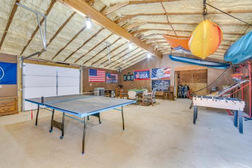 a garage with a ping pong table in it at Higden Studio with Shared Patio, Yard Games, Grills! in Fairfield Bay