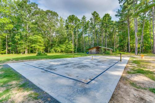 an empty basketball court in a park with trees at Higden Studio with Shared Patio, Yard Games, Grills! in Fairfield Bay