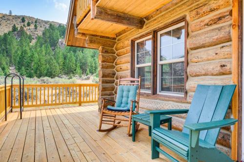 a deck with two chairs and a bench on a cabin at Riverfront Montana Log Cabin with Mountain Views! in Melrose