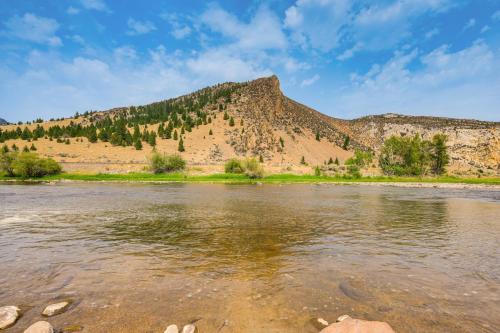 a view of a river with a mountain in the background at Riverfront Montana Log Cabin with Mountain Views! in Melrose