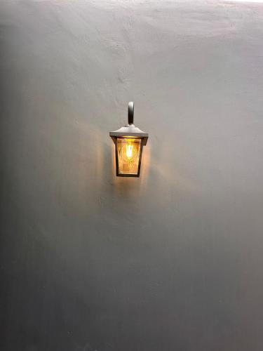 a light on the side of a wall at Azor International Hostel in Ponta Delgada