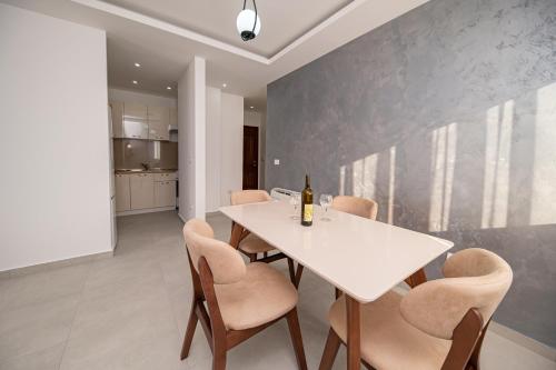 a dining room with a white table and chairs at Red Hill in Kotor