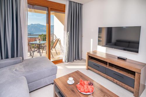 a living room with a couch and a tv at Red Hill in Kotor