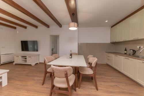 a kitchen with a table and chairs in a room at Red Hill in Kotor