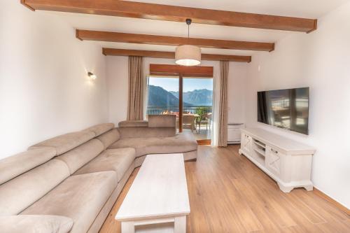 a living room with a couch and a tv at Red Hill in Kotor